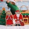 A chunky wooden Mrs Claus toy figure with Father Christmas and fireplace