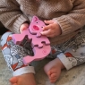 Child playing with the four piece pink pig and piglet wooden jigsaw puzzle