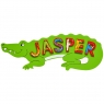 Large, flat wooden name plaque in green crocodile design with Jasper spelt in red letters