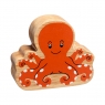 A chunky natural wood orange octopus figure in profile with a natural wood edge