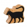 A chunky wooden black cat toy figure in profile