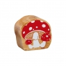 A chunky wooden red and white toadstool toy figure in profile